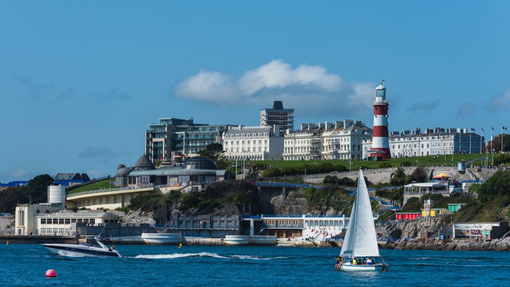 Boats at sea with seafront in the background