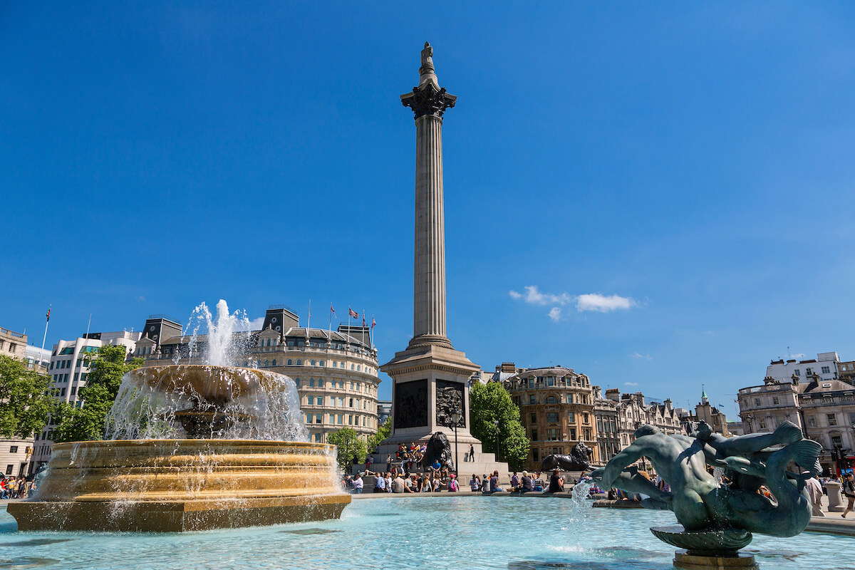 Trafalgar Square on a sunny day with the fountain on