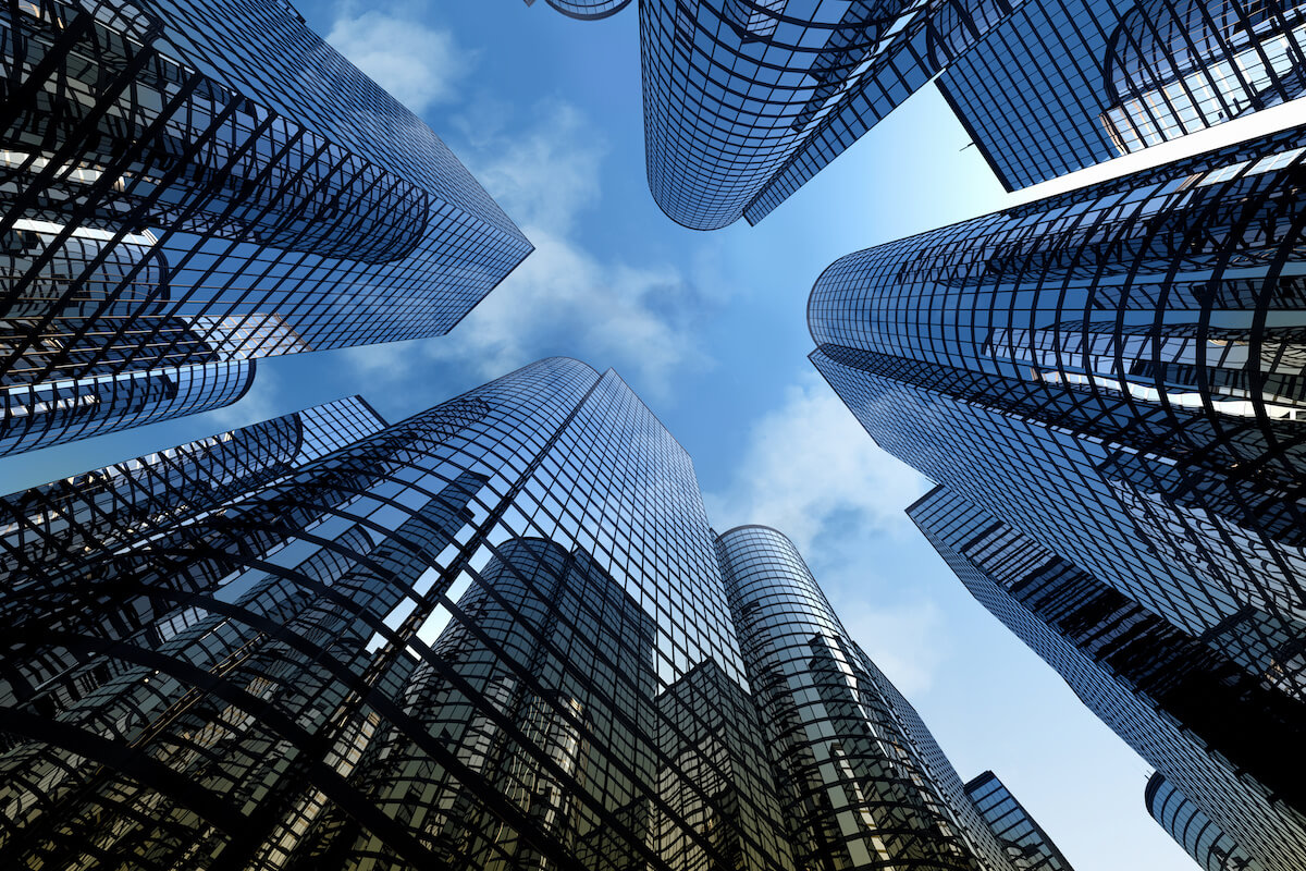 View from the ground looking up at modern city skyscrapers